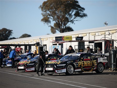 cars lined up in front of pits
